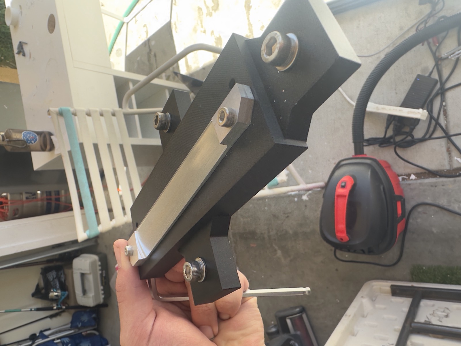Black CNC-machined fixture plate with socket head cap screws