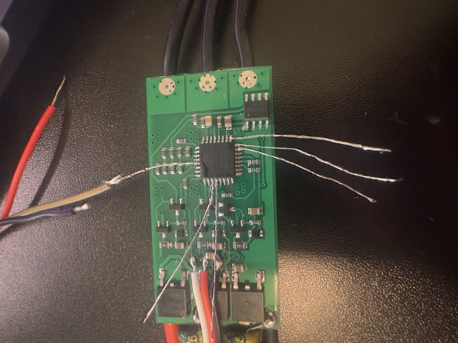 ESC circuit board with fine magnet wire soldered to the microcontroller